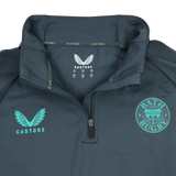 The Bath 24/25 Pro Players 1/4 Zip Midlayer by Castore features moisture-wicking fabric and displays the "BATH RUGBY" emblem alongside the Castore logo in teal on the chest.