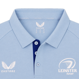 The Leinster 24/25 Pro Players Media Polo by Castore features a light blue design with a collar, Castore logo on the left chest, Leinster Rugby logo on the right chest, and contrasting blue buttons.
