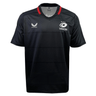 The Saracens 24/25 Replica Home Jersey by Castore features black short sleeves, a red collar, the Castore logo on the right chest, and a three-star Saracens badge on the left—a must-have classic for rugby fans.