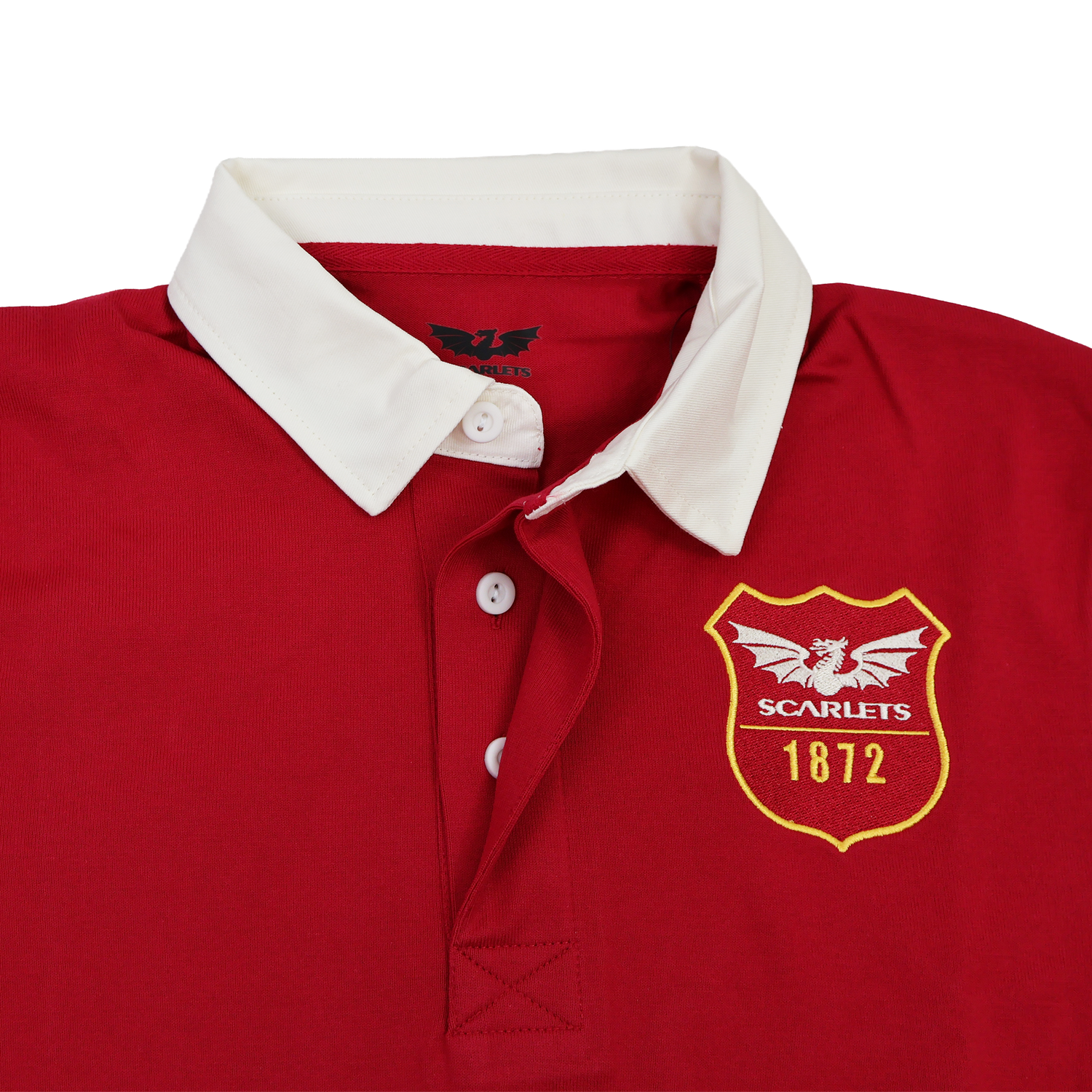 The Scarlets 24/25 Retro Rugby Jersey by Castore features a red body, white collar, three white buttons, and a chest emblem with a dragon, "SCARLETS," and "1872"—perfect for fans of classic rugby style.