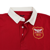 The Scarlets 24/25 Retro Rugby Jersey by Castore features a red body, white collar, three white buttons, and a chest emblem with a dragon, "SCARLETS," and "1872"—perfect for fans of classic rugby style.