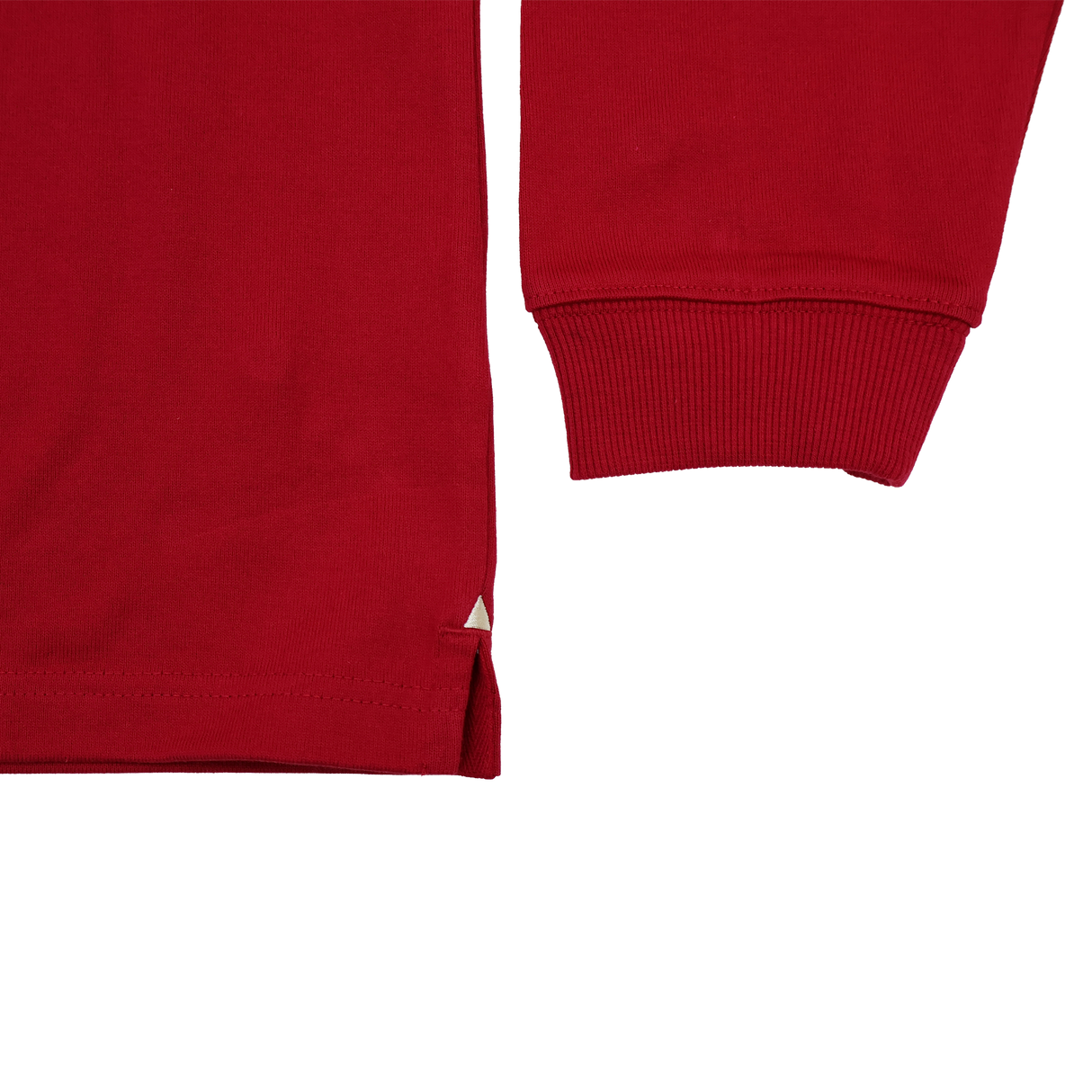 Close-up of the Scarlets 24/25 Retro Rugby Jersey by Castore, a red long-sleeve shirt inspired by classic rugby style, highlighting the cuff, lower hem with side slit, and set against a plain white background.