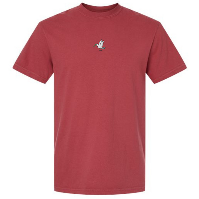 The Tonga Vintage Comfort Tee by EMB S&S Activewear is a maroon heavyweight shirt with a small embroidered green-headed, yellow-beaked duck on the chest.