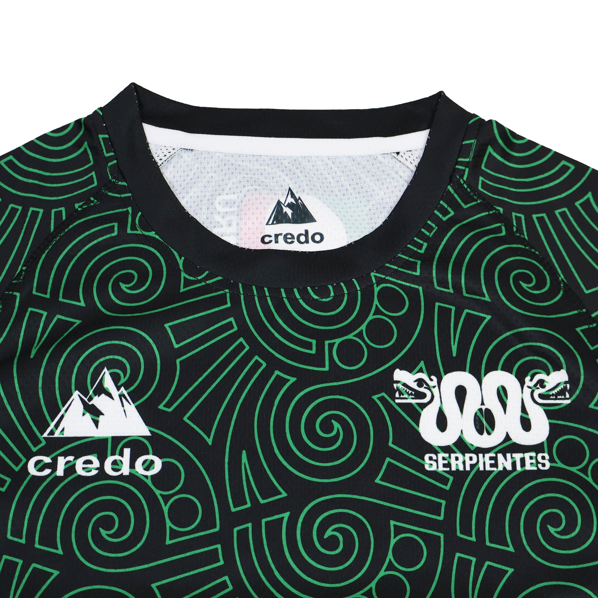 A close-up of the Las Serpientes Mexico Rugby Training Jersey by Credo Rugby displays green geometric patterns, the "credo" and "SERPIENTES" logos, plus a double snake graphic—unique to this distinctive training top.