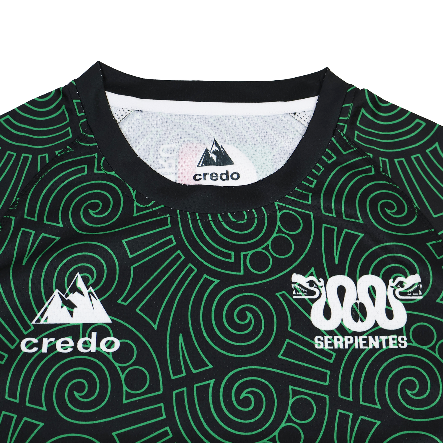 A close-up of the Las Serpientes Mexico Rugby Training Jersey by Credo Rugby displays green geometric patterns, the "credo" and "SERPIENTES" logos, plus a double snake graphic—unique to this distinctive training top.