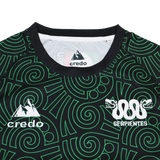 A close-up of the Las Serpientes Mexico Rugby Training Jersey by Credo Rugby displays green geometric patterns, the "credo" and "SERPIENTES" logos, plus a double snake graphic—unique to this distinctive training top.
