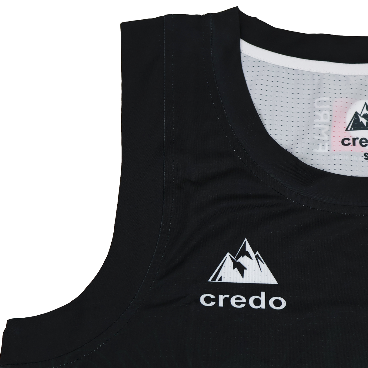 Close-up of the Las Serpientes Mexico Rugby Tank Top by Credo Rugby, a black athletic tank featuring a white mountain logo and "credo" on the chest—ideal for Credo Rugby fans or those wanting this stylish branded rugby wear.