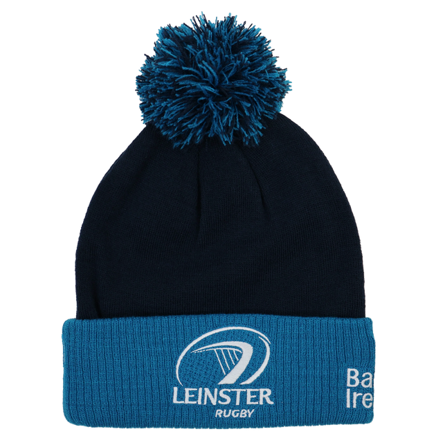 The Leinster Bobble Beanie 24/25 by Castore is a navy and blue hat with a pom-pom, embroidered crest, and text on the folded brim—an official accessory for true fans.