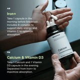 A person holds white capsules in one hand and a Momentous The Women’s Three™ bottle in the other, following directions to take their morning Iron supplement and evening Calcium with Vitamin D3 as part of the Momentous daily health system.