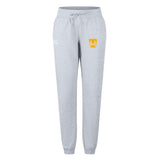 The Tacoma Tsunami Rugby Women's Leisure Sweatpant by EMB Canterbury features light gray fabric, a drawstring waist, and two front logos—a white logo on the left and a yellow and white "T" on the right—for everyday comfort.