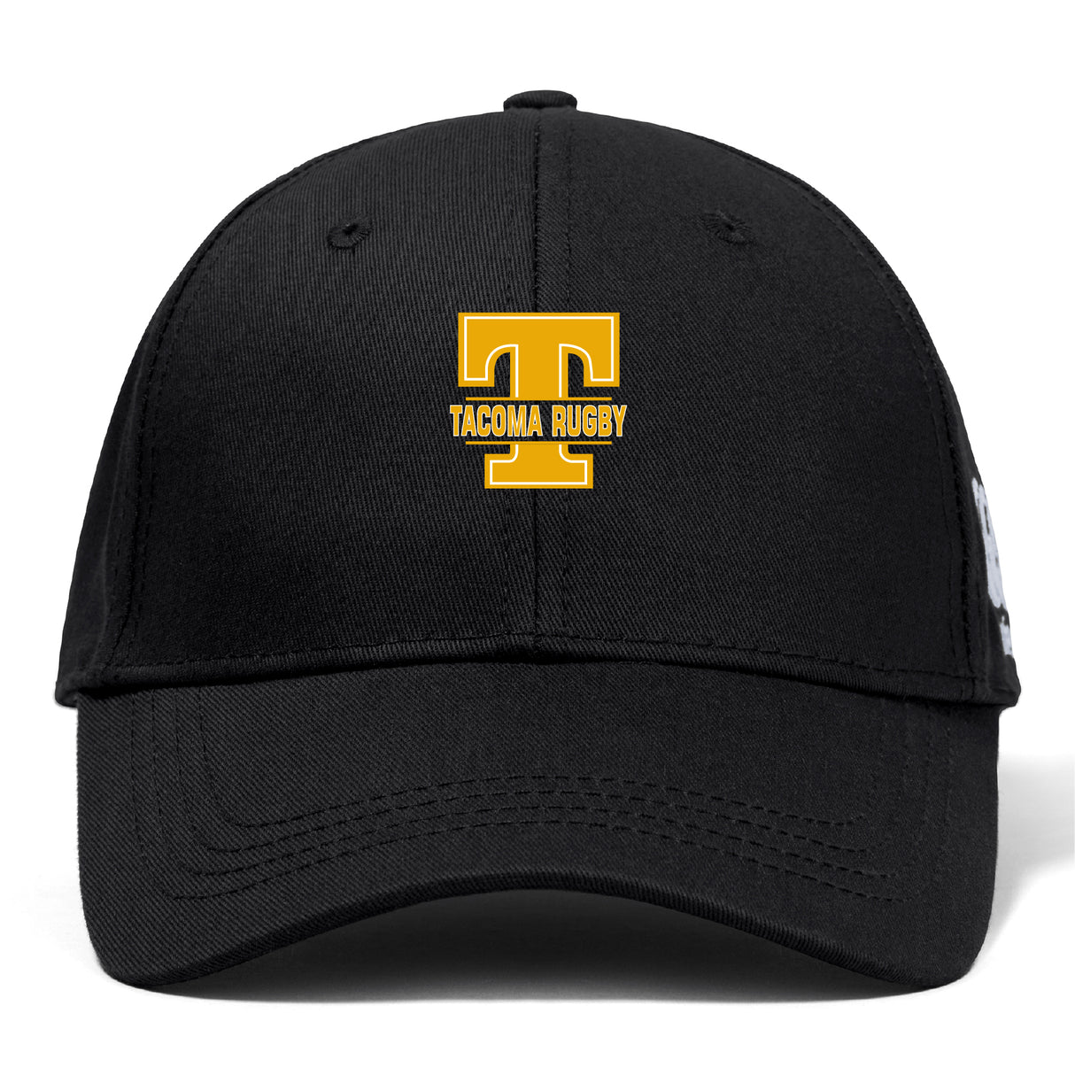 The EMB Canterbury Tacoma Tsunami Rugby Flexfit Drill Cap features a black design with a gold "T" and "TACOMA RUGBY" embroidered on the front.