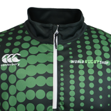 Close-up of the Teamatical CANTERBURY ECO-SUBLIMATE MID-LAYER Q-ZIP for men, featuring green and black colors with a white quarter zip, lightweight polyester, large green dots, and Canterbury plus World Rugby Shop logos.