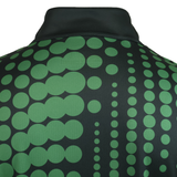 The back of the CANTERBURY ECO-SUBLIMATE MID-LAYER Q-ZIP by Teamatical features vertical rows of large and small green dots on black, crafted from lightweight polyester for men's comfort.