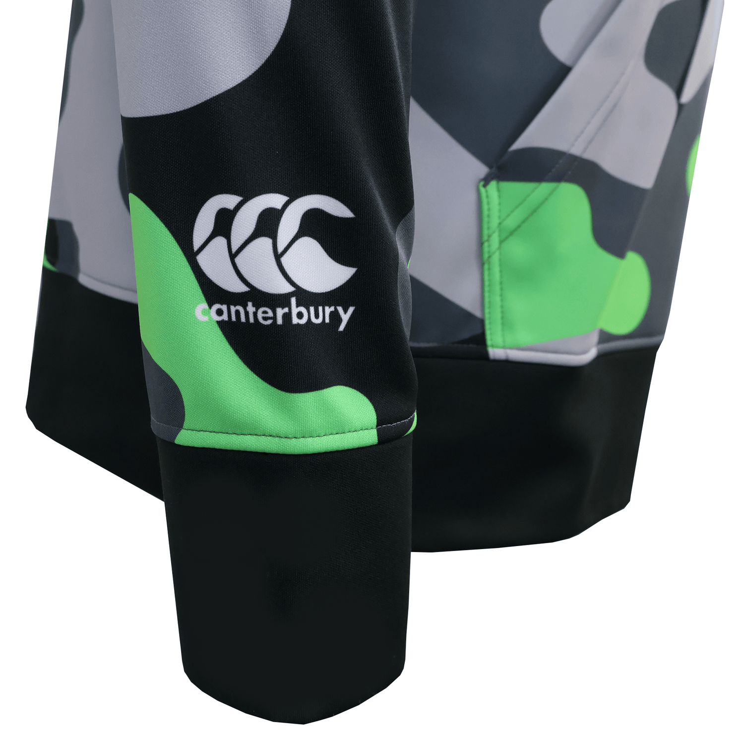 Close-up of the men's Canterbury Mid-Layer Sublimate Hoodie sleeve by Teamatical, featuring green, black, and gray abstract patterns with a visible white Canterbury logo.