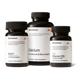 Three bottles of Momentous The Women’s Three™ by Momentous are shown, featuring Iron+, Calcium, and Vitamin D3 supplements as a daily health system for women against a plain background.