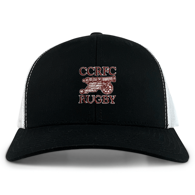 The Concord Carlisle Rugby Retro Trucker Cap by EMB S&S Activewear features a black and white mesh design, snapback closure, and a bold red and white “CCRFC Rugby” embroidery with cannon graphic on the front.