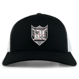 The Troy University Rugby Retro Trucker Cap by EMB S&S Activewear is a black and white cap with an embroidered crest on the front and a snapback closure for adjustable comfort.