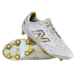 A pair of New Balance 442 Elite FG v3 soccer cleats in Sea Salt/Gold Metallic, one upright and one on its side, showcase DynamicTouch Tech for superior control and gold-accented firm ground studs.