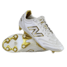 A pair of New Balance 442 Elite FG v3 soccer cleats in Sea Salt/Gold Metallic, one upright and one on its side, showcase DynamicTouch Tech for superior control and gold-accented firm ground studs.