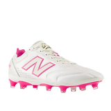 The New Balance Wide 442 Elite FG v3 in Sea Salt/Pink Heat, a white soccer cleat with pink accents and studs for firm ground, is shown front-facing on a plain background—perfect for players needing wide football boots.