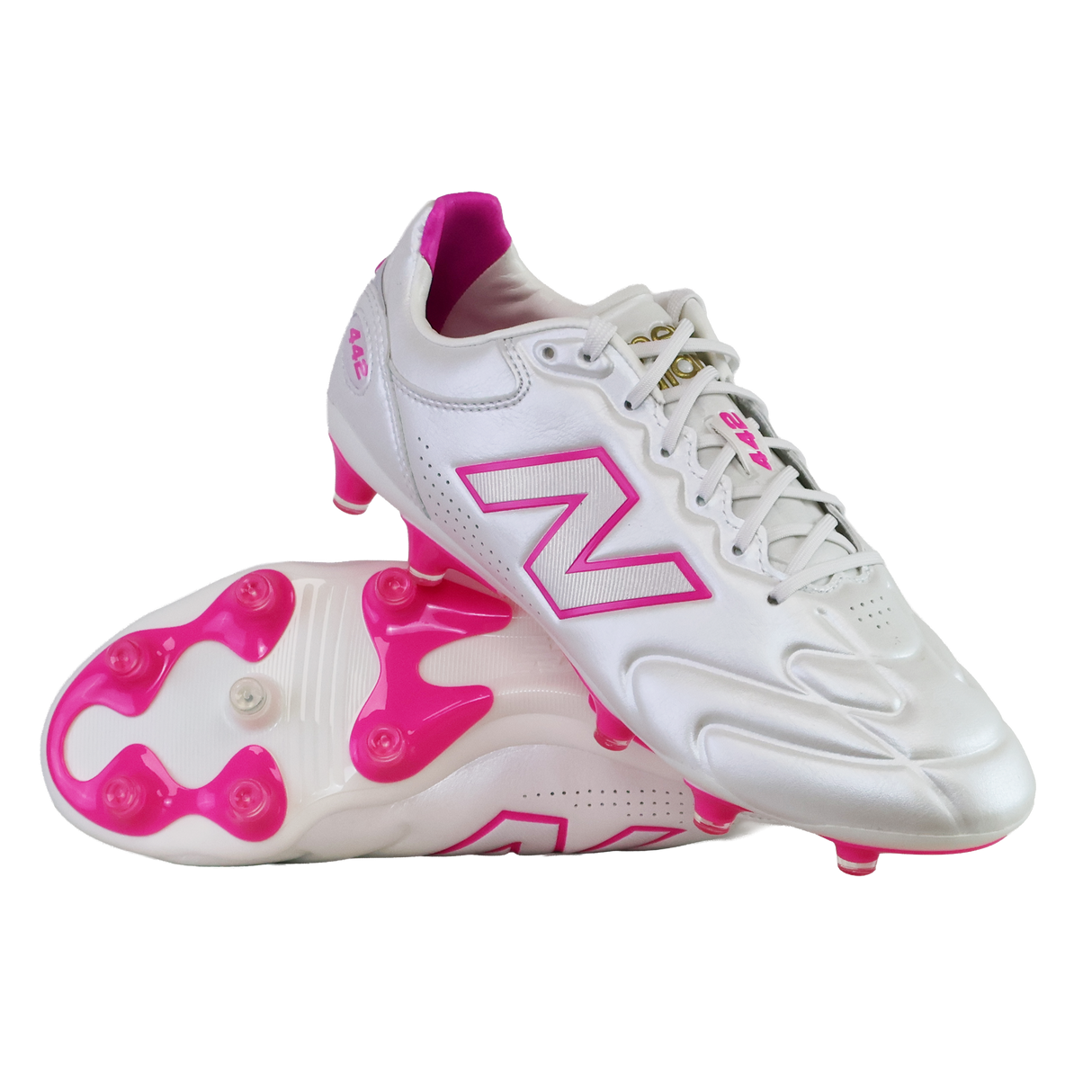 A pair of New Balance 442 Elite FG v3 soccer cleats in Sea Salt/Pink Heat, featuring pink accents and studs with the New Balance logo, displayed on a white background.