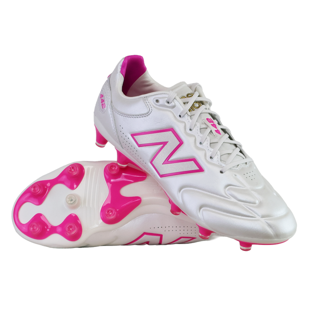 A pair of New Balance 442 Elite FG v3 soccer cleats in Sea Salt/Pink Heat, featuring pink accents and studs with the New Balance logo, displayed on a white background.