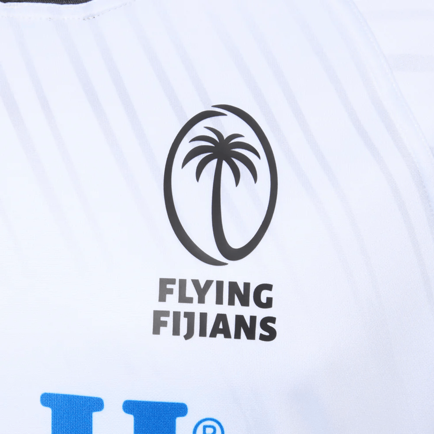 The Fiji 25/26 Replica Home Jersey by Umbro is a white jersey featuring the Flying Fijians logo with a black palm in an oval, "FLYING FIJIANS" below, and subtle masi art details for cultural flair.