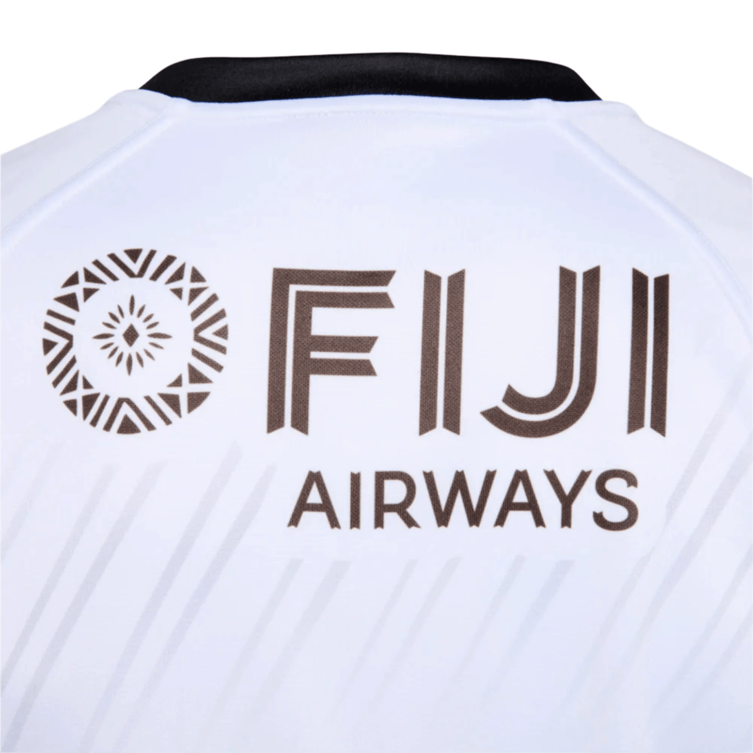 A close-up of the back of the Fiji 25/26 Replica Home Jersey by Umbro shows the bold "FIJI AIRWAYS" logo and a circular geometric Fijian Masi Art-inspired pattern above it.