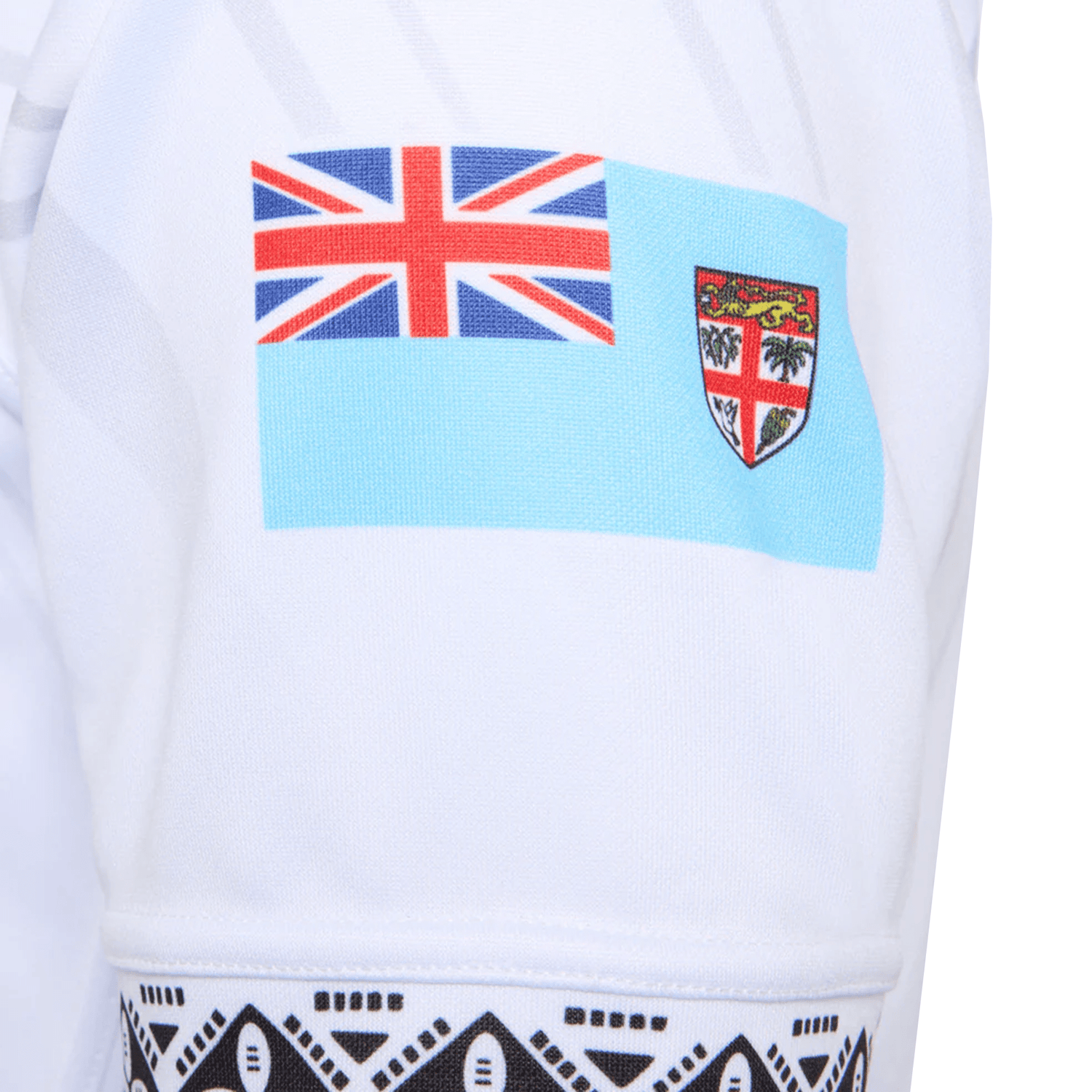 A close-up of a sleeve from the Fiji 25/26 Replica Home Jersey by Umbro, featuring the Fiji flag on white fabric with black geometric patterns inspired by traditional Fijian masi art.