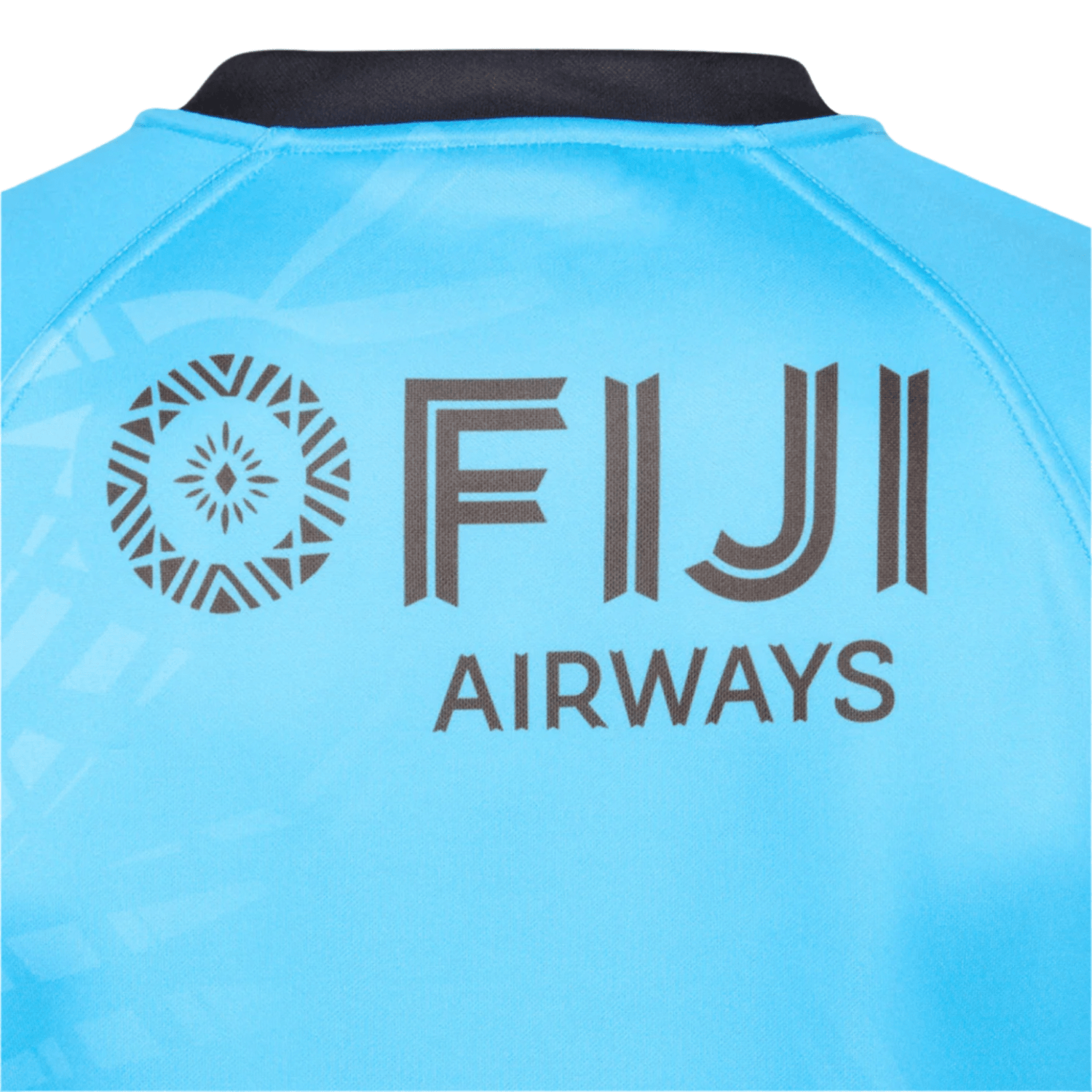 Back of the blue Fiji 25/26 Replica Away Jersey by Umbro featuring a black "FIJI AIRWAYS" logo and a circular geometric motif inspired by Fijian masi art on the left.
