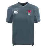 The University of Oklahoma Women Vapodri Evader Jersey by EMB Canterbury, in gray, showcases the "Canterbury" logo on the right chest and "OU Rugby Club" logo on the left. It features a V-neck, short sleeves, and moisture-wicking technology for comfort during intense matches.