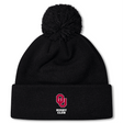 The University of Oklahoma Women Pom Pom Beanie by EMB Canterbury is a black beanie featuring a large pom-pom and a front logo with a red "O," "U," and "Rugby Club" in white. Fleece-lined for warmth, it's ideal for chilly days to display your Canterbury Rugby pride.