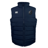 The Uruguay Shield Core Gilet by EMB Canterbury is a navy blue puffer vest with a high collar, featuring two logos on the chest and Thermoreg insulation for added warmth.