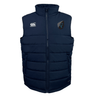 The Uruguay Shield Core Gilet by EMB Canterbury is a navy blue puffer vest with a high collar, featuring two logos on the chest and Thermoreg insulation for added warmth.