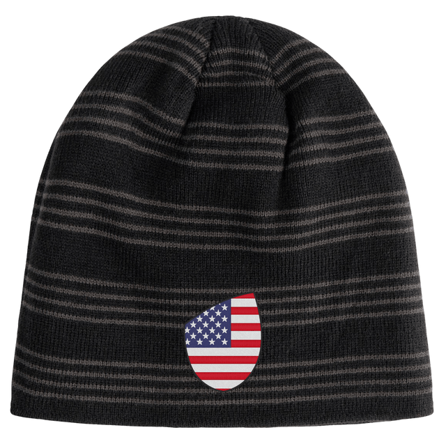 The EMB Canterbury USA Shield Beanie sports a dark striped pattern with an American flag shield emblem prominently on the front.