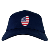 A USA Shield Flex Drill Cap by EMB Canterbury in navy blue, featuring a front design of an American flag.