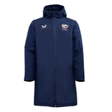 Navy blue long coat with a hood, featuring logos on the chest and an insulated lining. This stylish and functional piece is known as the USA Rugby Long Length Bench Jacket by Castore.