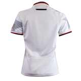 The Women's USA Rugby WRWC25 Replica Away Jersey by Macron displays subtle gray patterns, a small American flag on the sleeve, and red and blue cuff trim—a must-have authentic away jersey for devoted USA Rugby fans.