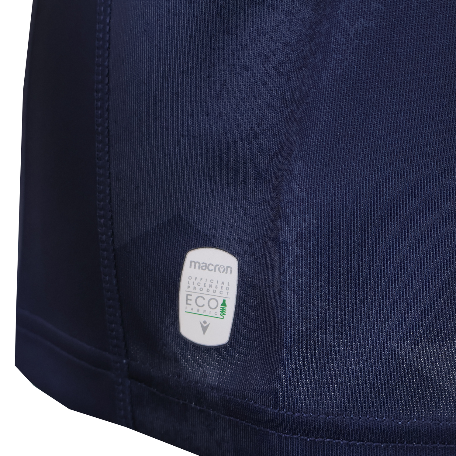 Close-up of the Women's USA Rugby WRWC25 Replica Home Jersey by Macron, featuring a "Macron Official Licensed Product ECO" label near the hem.