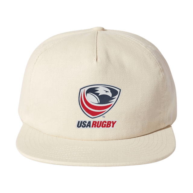The EMB Weld USA Rugby Crest Brushed Cotton Cap is a stylish beige hat with an intricately embroidered USA Rugby logo, featuring an eagle and rugby ball on the front.