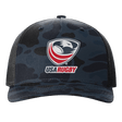 The EMB S&S Activewear USA Rugby Printed Five-Panel Trucker Cap comes in black and dark blue camo, featuring the iconic eagle and red rugby ball logo, plus an adjustable snapback for a comfortable fit.