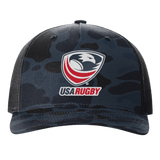 The EMB S&S Activewear USA Rugby Printed Five-Panel Trucker Cap comes in black and dark blue camo, featuring the iconic eagle and red rugby ball logo, plus an adjustable snapback for a comfortable fit.