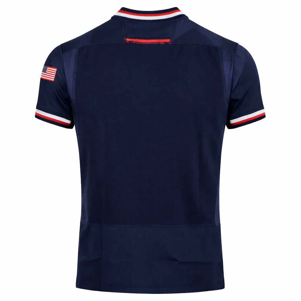 Back of the USA Rugby 24/25 Authentic Matchday Home Jersey by Macron in navy, with red, white, and blue trim and a small American flag patch on the right sleeve—official gear from Macron.