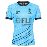 The Fiji 7's 25/26 Replica Away Jersey by Umbro features a light blue design with black collar and sleeve trim, palm logo, and bold blue and black diagonal lines.