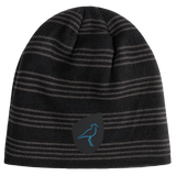 Just In: The Uruguay Shield Beanie by EMB Canterbury features stylish black and gray stripes and a blue bird logo on a sleek black patch, capturing the vibrant spirit of Uruguay.