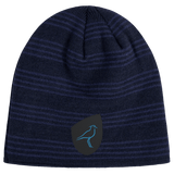 The EMB Canterbury Uruguay Shield Beanie in blue and black stripes showcases a unique bird logo, capturing Uruguay's vibrant energy.