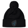 The Uruguay Shield Pom Pom Beanie by EMB Canterbury showcases a stylish black design with a striking blue bird logo on the front, combining fashion and warmth perfectly.