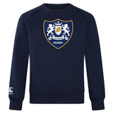The Villanova Rugby Club Crew Sweatshirt by WRS Canterbury features a navy blue color, embroidered "Villanova Rugby" crest with two lions and shield on the chest, and a Canterbury logo on the lower sleeve for ultra-soft comfort.