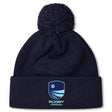 Stay warm on chilly days with the Rugby VA Pom Pom Beanie by Canterbury. This navy blue fleece-lined knit hat features a pom-pom, embroidered blue shield logo, and "Rugby Virginia" text on the front cuff. Brand: EMB Canterbury.