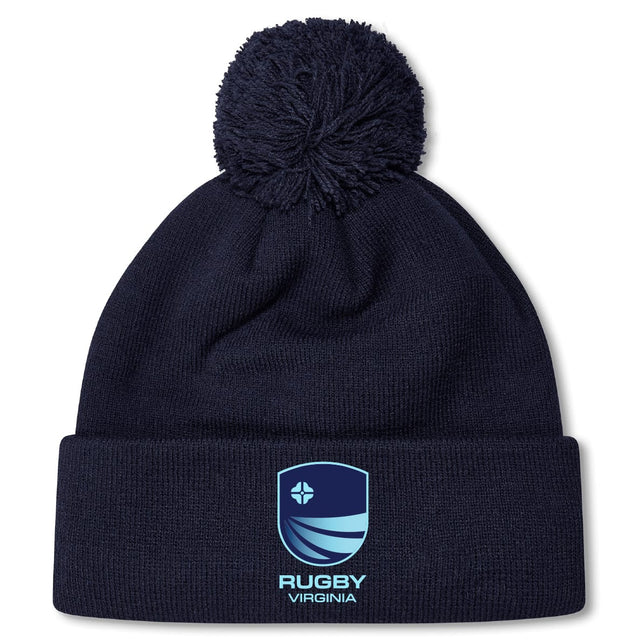 Stay warm on chilly days with the Rugby VA Pom Pom Beanie by Canterbury. This navy blue fleece-lined knit hat features a pom-pom, embroidered blue shield logo, and "Rugby Virginia" text on the front cuff. Brand: EMB Canterbury.